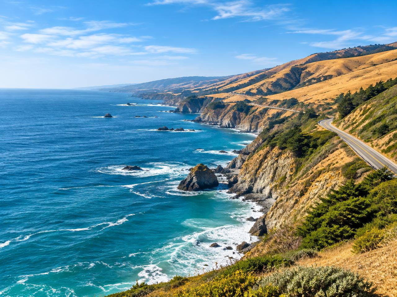California's Highway 1 winding along golden hills above the Pacific Ocean